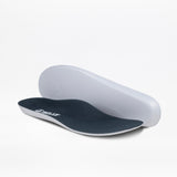 A pair of contoured Men's Navy/Green BILLY Inclusion Trail insoles from BILLY Footwear, featuring dark tops and white bottoms, are shown on a plain white background—one flat and one propped up behind it.