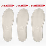 Three white soles for the Women's Black/White BILLY CS Low by BILLY Footwear, labeled Medium, Wide, and Extra-Wide, feature textured patterns and a goat logo near the heel, providing sensory-friendly shoe options.